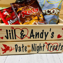 Load image into Gallery viewer, Wooden crate with your names and date night treats on it with hearts and cupid