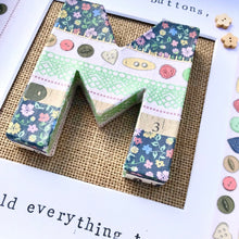 Load image into Gallery viewer, mum's are like buttons they hold everything together framed picture with decoupaged M in the middle with buttons