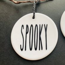 Load image into Gallery viewer, white bauble with black string and the word spooky
