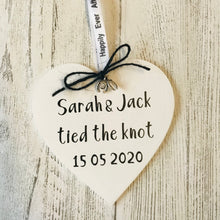 Load image into Gallery viewer, cream tied the knot hanging heart personalised with couples names with black bow