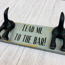 Load image into Gallery viewer, wooden plaque with two dog lead hooks and the text lead me to the bar