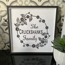 Load image into Gallery viewer, black square framed picture of family name in wreath black and white