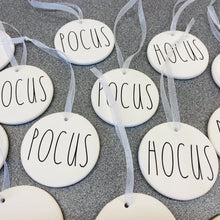 Load image into Gallery viewer, white bauble with black string and the word hocus or pocus