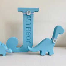 Load image into Gallery viewer, blue engraved name initial with 2 dinosaur figures