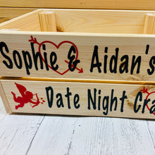 Load image into Gallery viewer, Wooden crate with your names and date night treats on it with hearts and cupid