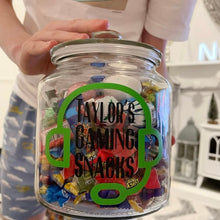 Load image into Gallery viewer, personalised gaming snack jar with lid, headphone image with name&#39;s gaming snacks on the front
