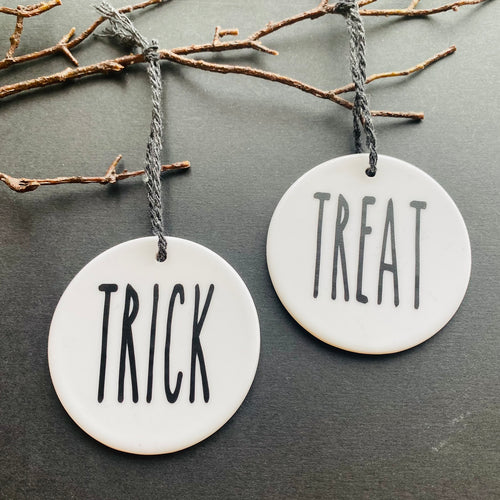 white bauble with black string and the word trick or treat