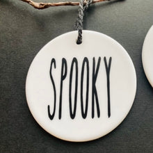 Load image into Gallery viewer, white bauble with black string and the word spooky
