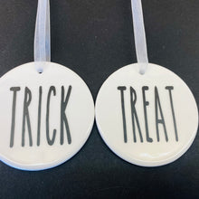 Load image into Gallery viewer, white bauble with black string and the word trick or treat
