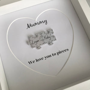 box frame with names on jigsaw pieces and daddy/mummy we love you to pieces