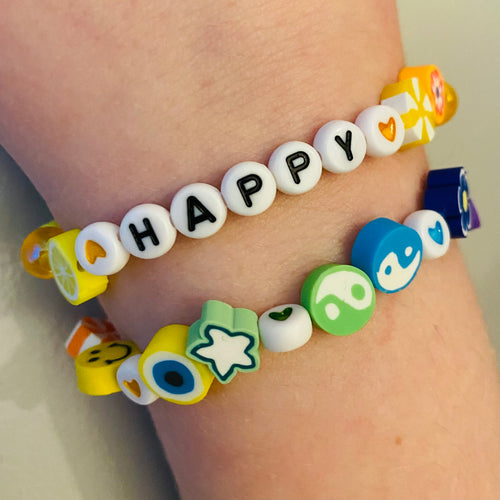 elasticated mixed beaded bracelet with happy word in yellow green blue