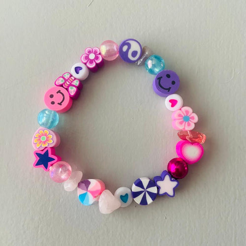 pink and lilac elasticated bracelet with mixed beads flowers hearts