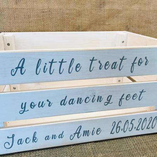 large wooden crate painted white to store flip flops in at a wedding personalised with names