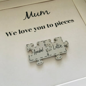 box frame with names on jigsaw pieces and daddy/mummy we love you to pieces