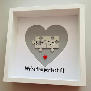 box framed personalised gift with 2 jigsaw pieces with names on we're the perfect fit underneath