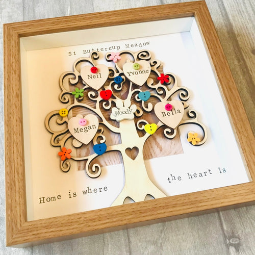 wooden family tree framed with bright buttons names on hearts