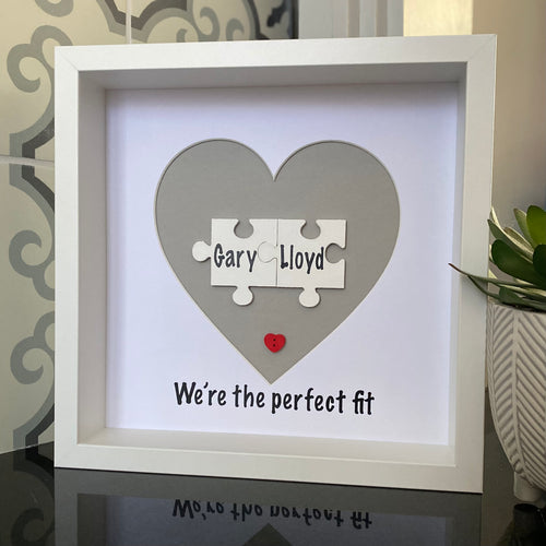 box framed personalised gift with 2 jigsaw pieces with names on we're the perfect fit underneath