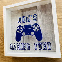 Load image into Gallery viewer, personalised gaming fund money box in a frame with controller image
